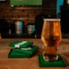 Four football cup coasters and a beer.