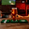 Football cup coasters and a beer.