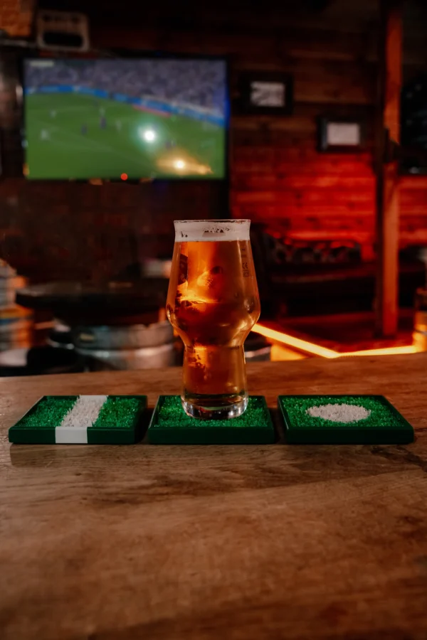 Football cup coasters and a beer.