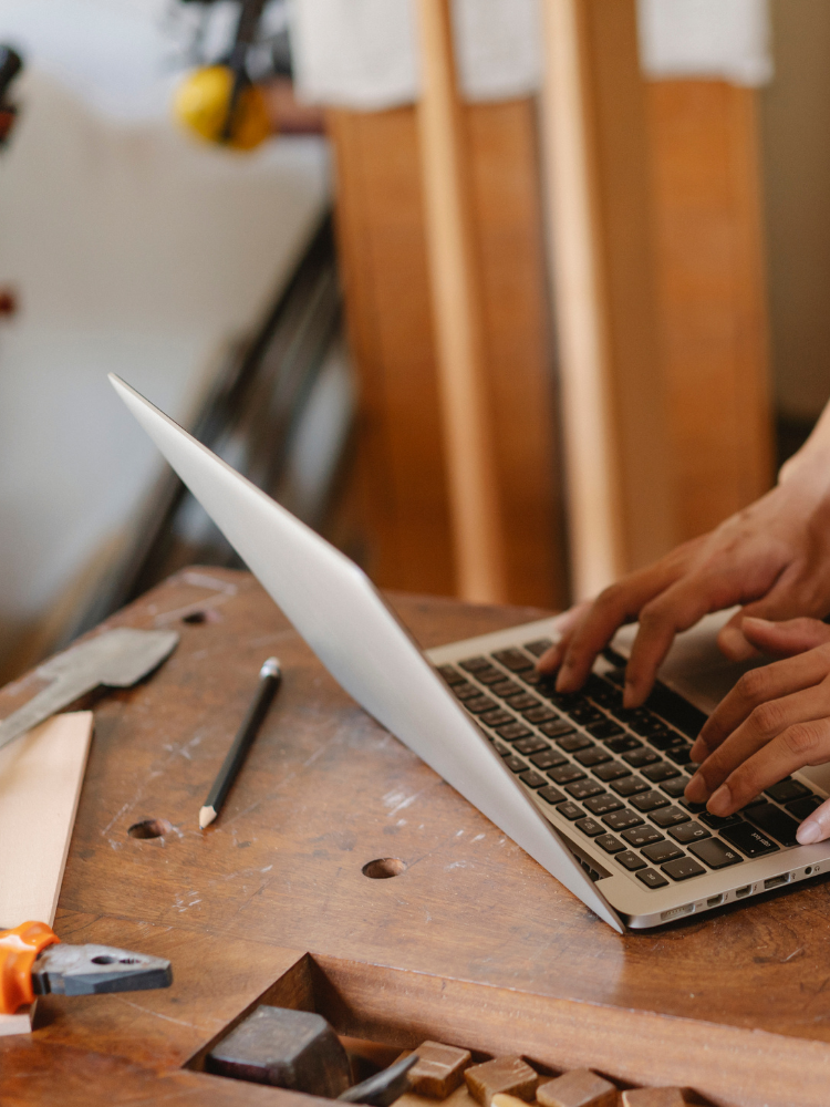 Craftsman using laptop.